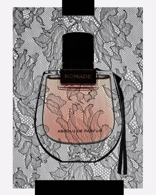 Close-up of Nomade Absolu de Parfum bottle with a black stopper, featuring intricate black floral lace patterns in the background.