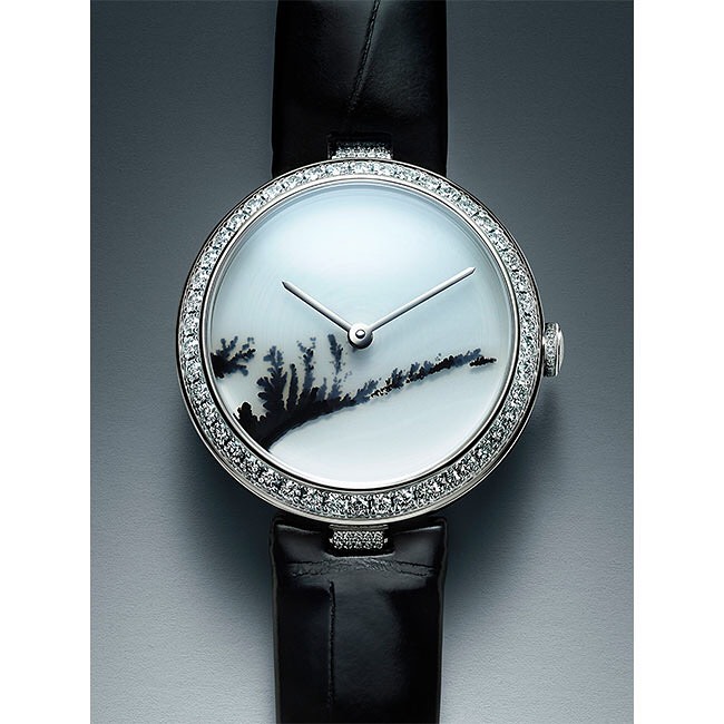 Elegant wristwatch featuring a white dial with black dendritic patterns, set in a diamond-encrusted bezel and paired with a black leather strap.