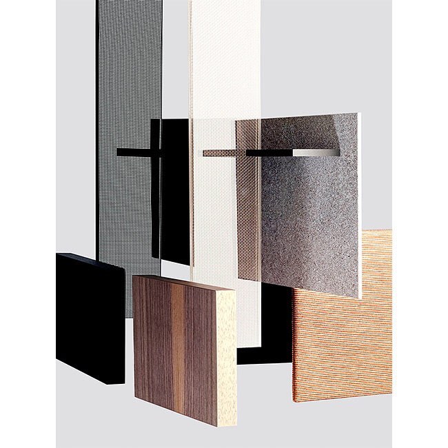 Abstract arrangement of rectangular wooden and textured panels in varying shades of brown, gray, black, and white against a light gray backdrop.