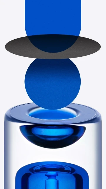 Abstract glass sculpture with blue and gray geometric shapes. Artful composition, minimal background, studio lighting, and cool color palette.