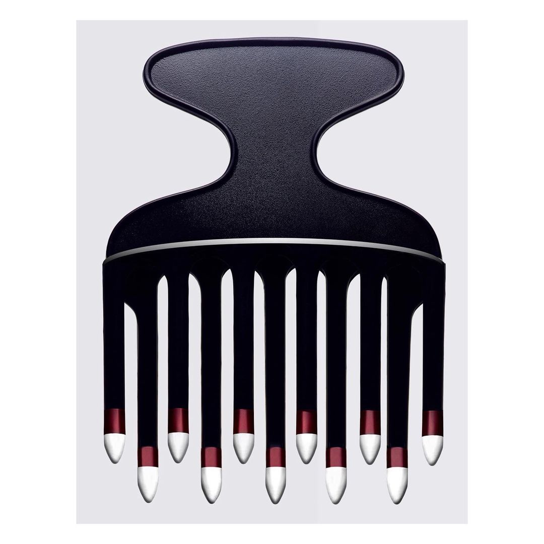 Studio shot of a black hair pick with red and white accents against a light grey background, showcasing a modern design and hair care tool.