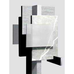 An abstract sculptural arrangement of overlapping rectangular panels in marble, wood, and textured fabrics against a neutral background