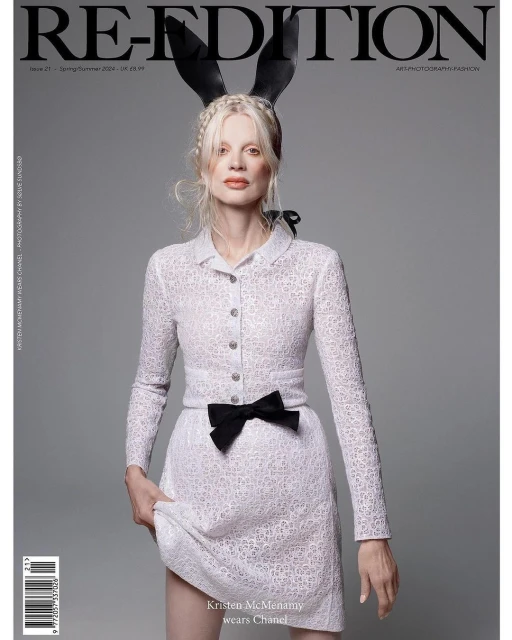 Magazine cover featuring a model with blonde hair wearing bunny ears and a white dress with a black bow, posing against a gray backdrop.