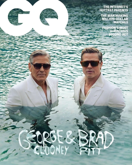 GQ Magazine cover featuring George Clooney and Brad Pitt in water wearing suits and sunglasses for a celebrity and entertainment themed photoshoot.