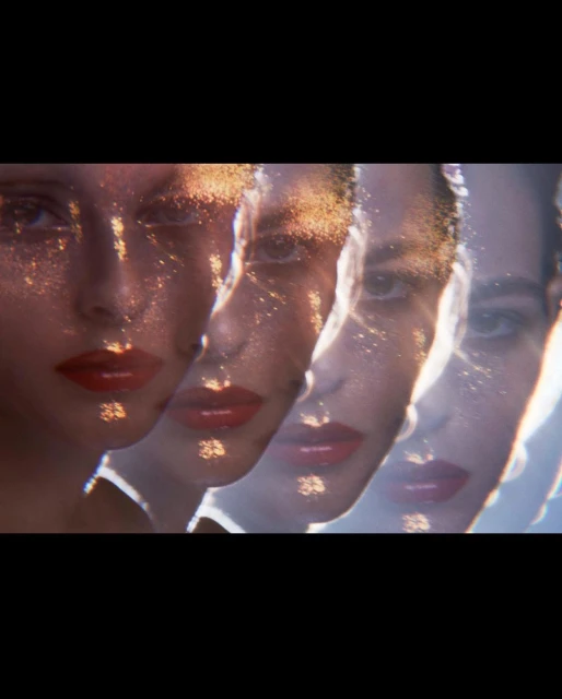 Artistic portrait of a woman with makeup and glitter overlayed in a triple exposure effect, creating a dreamy, ethereal aesthetic.