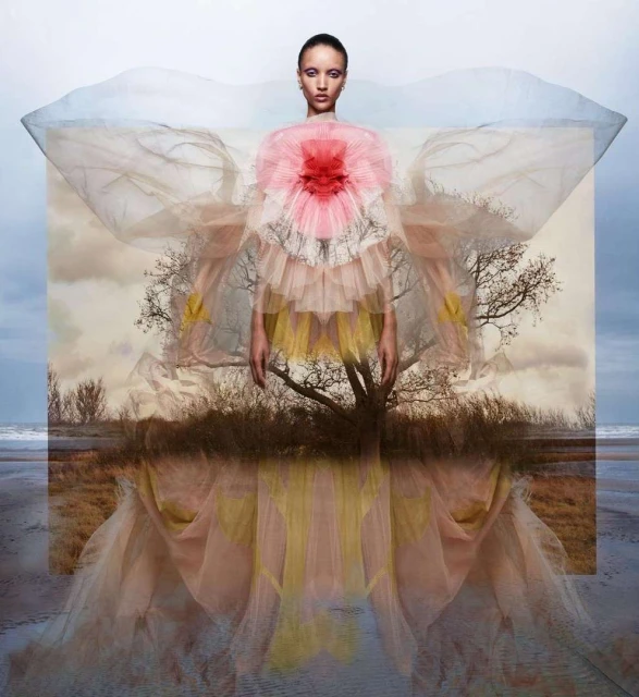 Elegant woman in a flowing pink and yellow gown, standing against a beach landscape, creating a surreal fashion portrait with soft lighting.