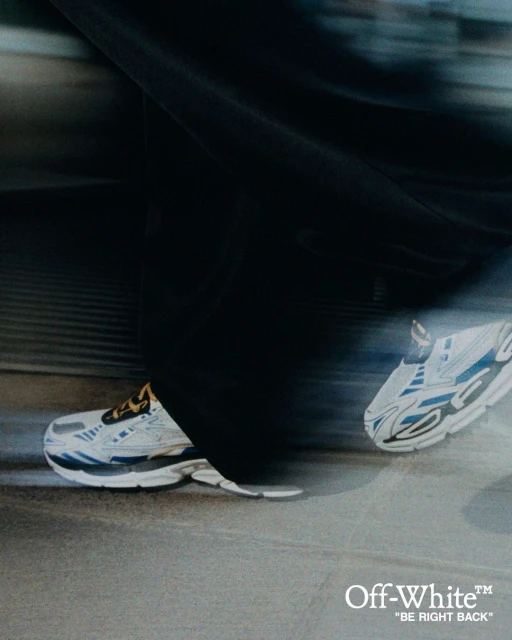 Athletic shoes by Off-White in motion on pavement with blurred background. Sporty footwear designed for fitness and urban lifestyle.