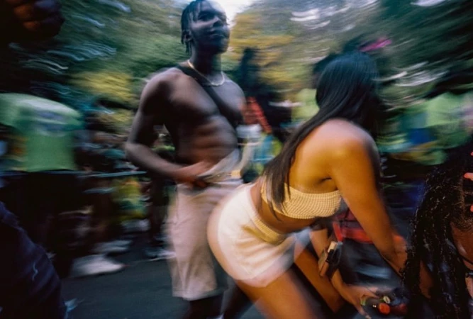 Motion blur photograph by Sophie Jones of people dancing outdoors at a crowded event in London.