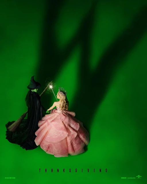 Two costumed figures, one in green and the other in pink, stand against a green background with shadows. They are holding wands.