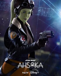 Green-skinned female pilot holding a blaster pistol, wearing a leather jacket, goggles, and headgear in a cinematic portrait.