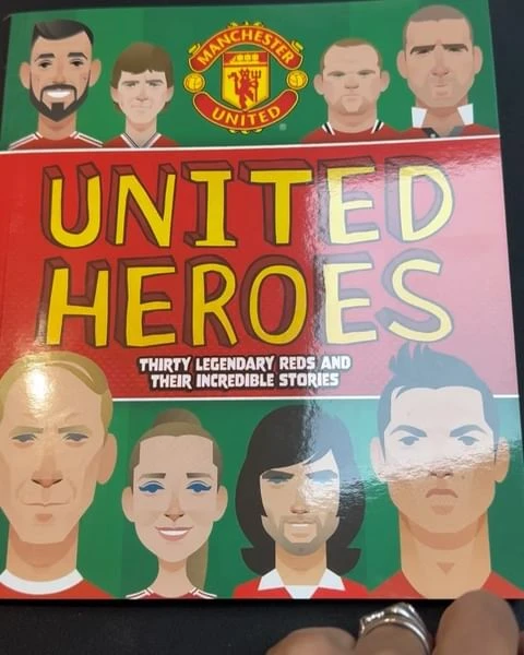 Manchester United Heroes book cover featuring illustrated portraits of soccer players. Book cover has green, red, white, and yellow text.