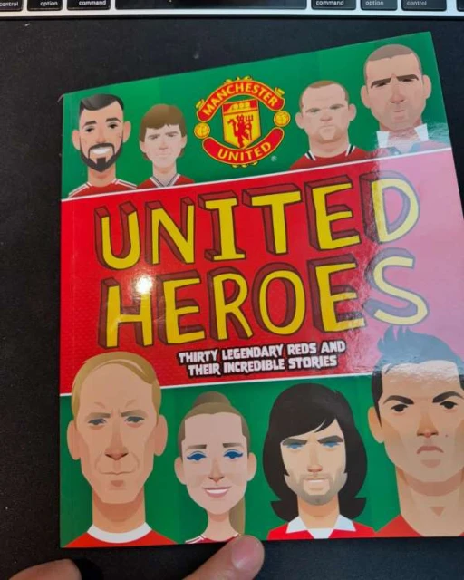 Book cover featuring cartoon portraits of Manchester United players and the team logo on a red and green background.