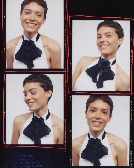 Four images of a smiling woman with short brown hair, wearing a white top with a black ribbon, set against a black background.