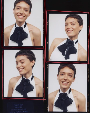 Four images of a smiling woman with short brown hair, wearing a white top with a black ribbon, set against a black background.