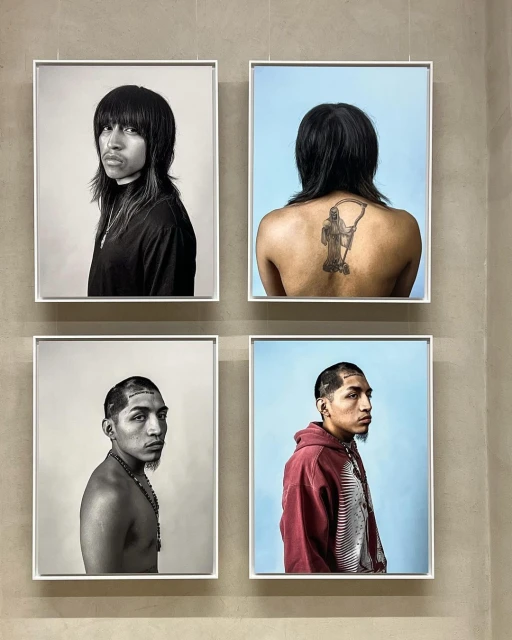 Four framed portraits hang on a neutral wall, showcasing diverse individuals with distinct hairstyles and expressions in a gallery setting.