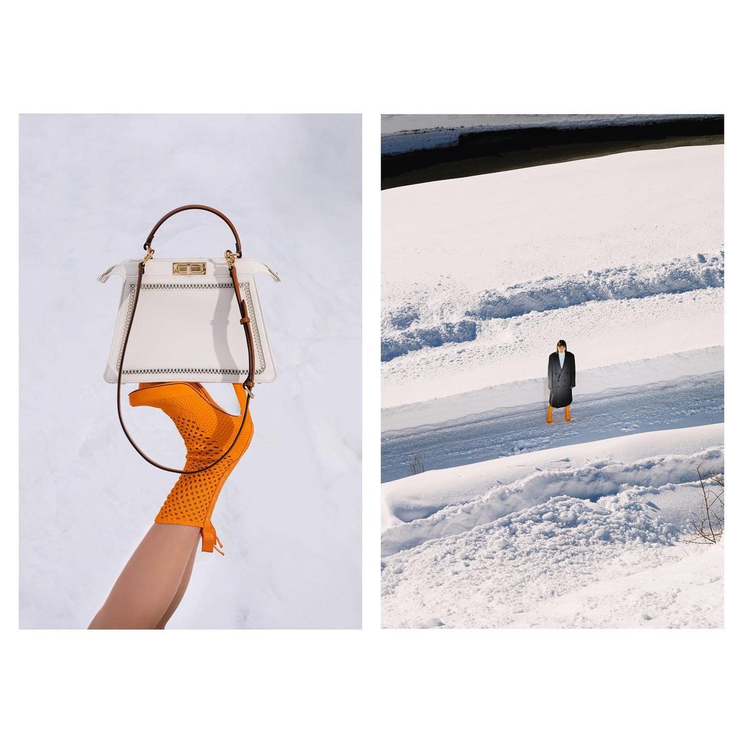 Fashion still life: A cream Fendi Peekaboo bag is styled with an orange mesh sock boot on a snowy background with a figure in black. 