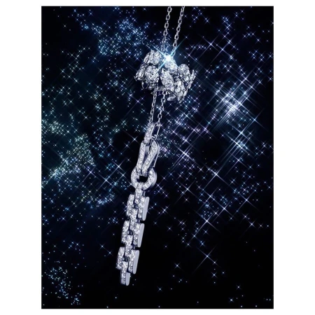 Elegant diamond and white gold pendant necklace with delicate chain on a sparkling starfield background in a jewellery studio shot.