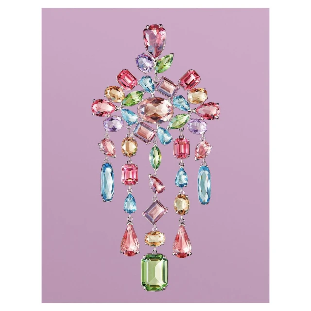 Elegant arrangement of multi-colored gemstones in a chandelier-like cascading design on a light purple background. Jewellery advertisement.