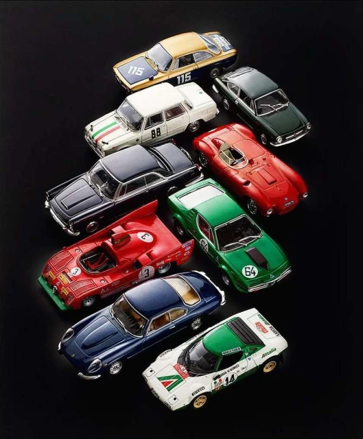 Collection of vintage car model toys displayed on black background, showcasing multiple colors and designs.