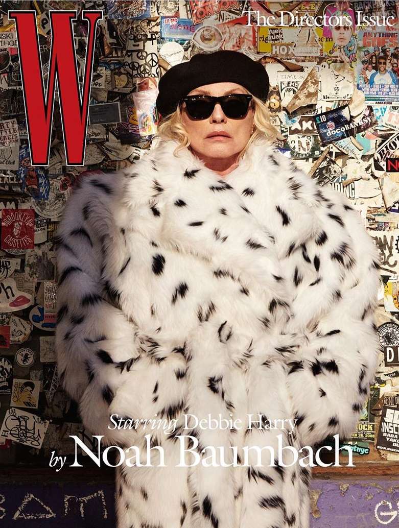 Magazine cover featuring Debbie Harry wearing sunglasses and a black and white spotted fur coat, in front of a wall with stickers.