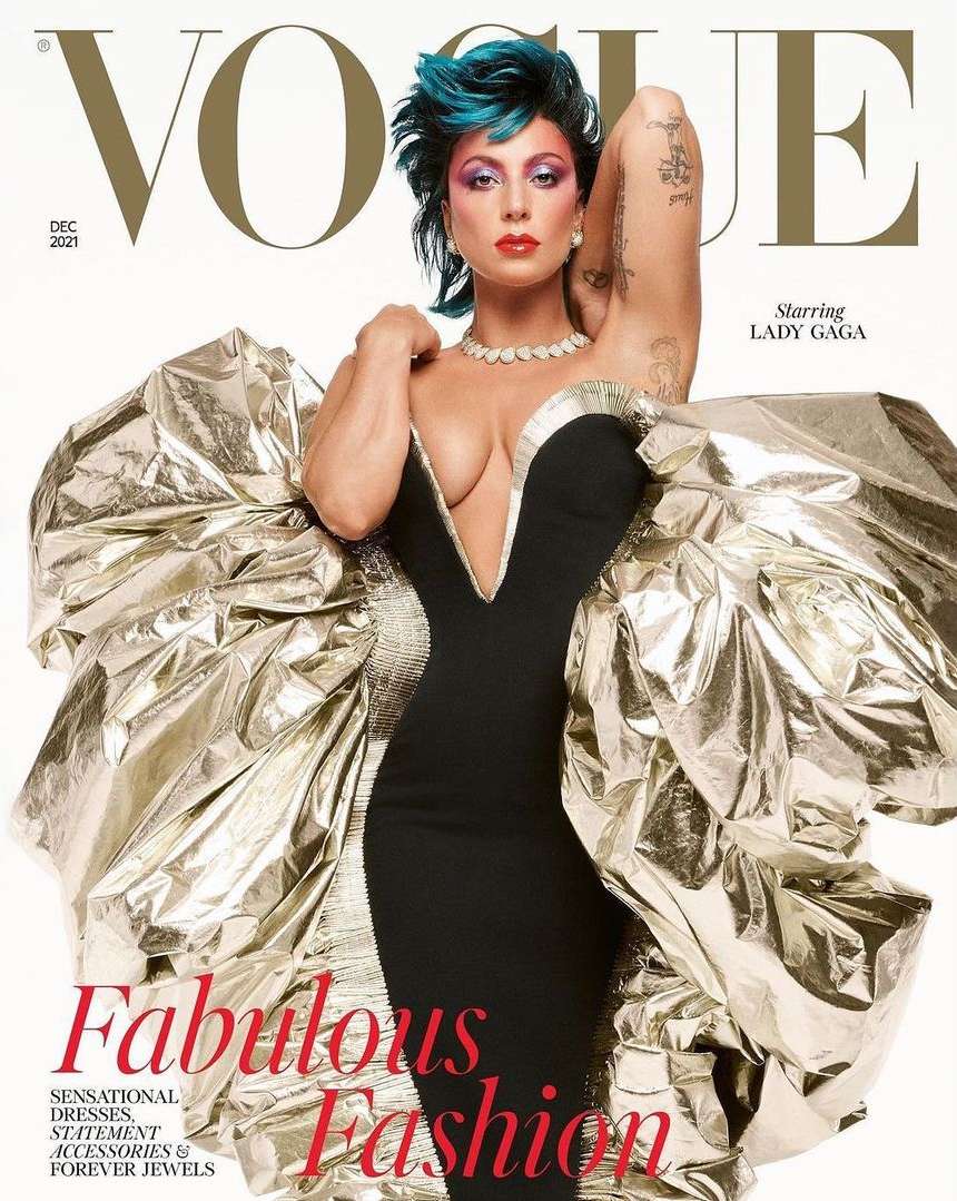Vogue magazine cover featuring Lady Gaga in a black dress with a plunging neckline, statement jewelry, and silver ruffled sleeves.
