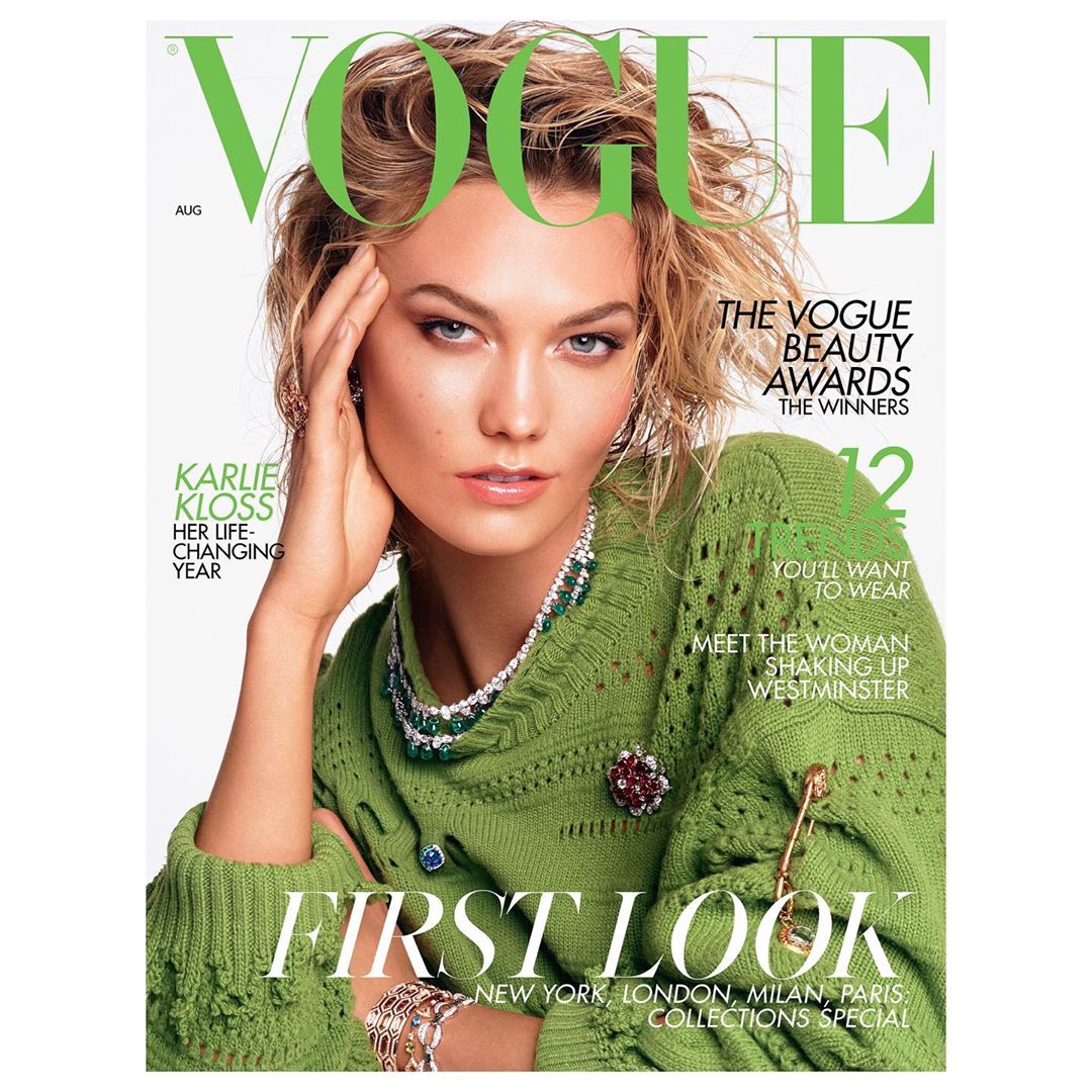Vogue magazine cover featuring model Karlie Kloss wearing a green sweater, jewelry, and bracelets, with magazine text overlays.