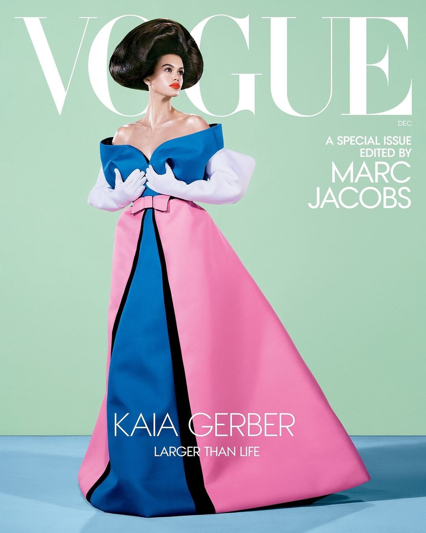 Vogue cover featuring Kaia Gerber in an off-the-shoulder blue and pink gown, styled with large white gloves, against a mint-green background.