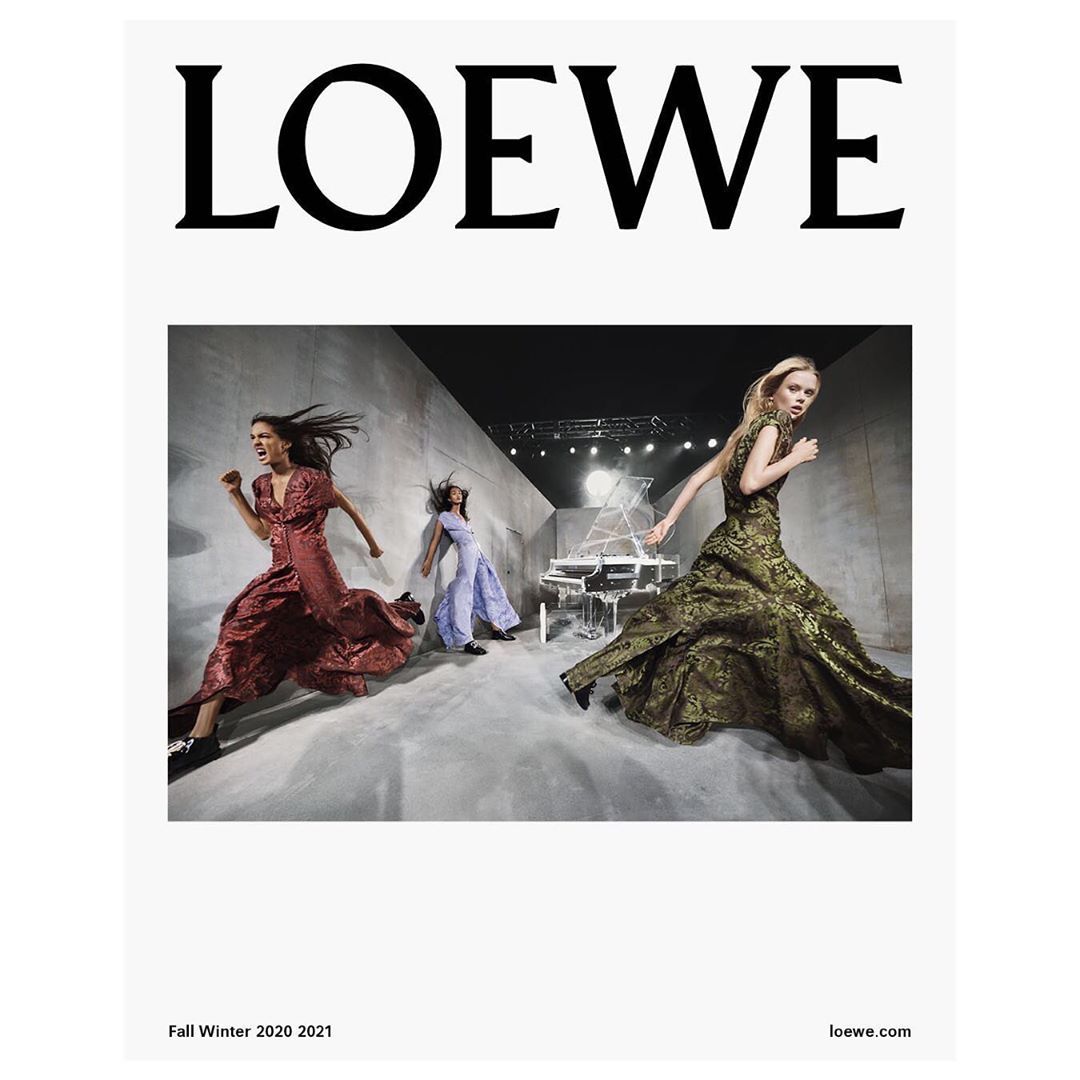 Loewe fashion advertisement featuring three female models wearing long gowns, running in a studio with a white piano in the background.