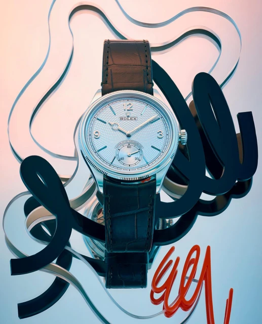 Elegant silver wristwatch with black leather strap, featuring swirling black and orange shapes on a gradient pink-to-blue backdrop.