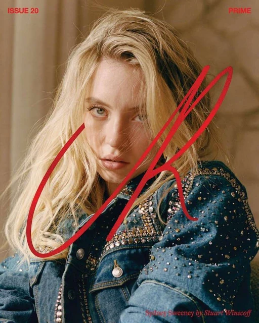 Close-up portrait of a blond woman, Sydney Sweeney, wearing a denim jacket with embellishments against a neutral background.