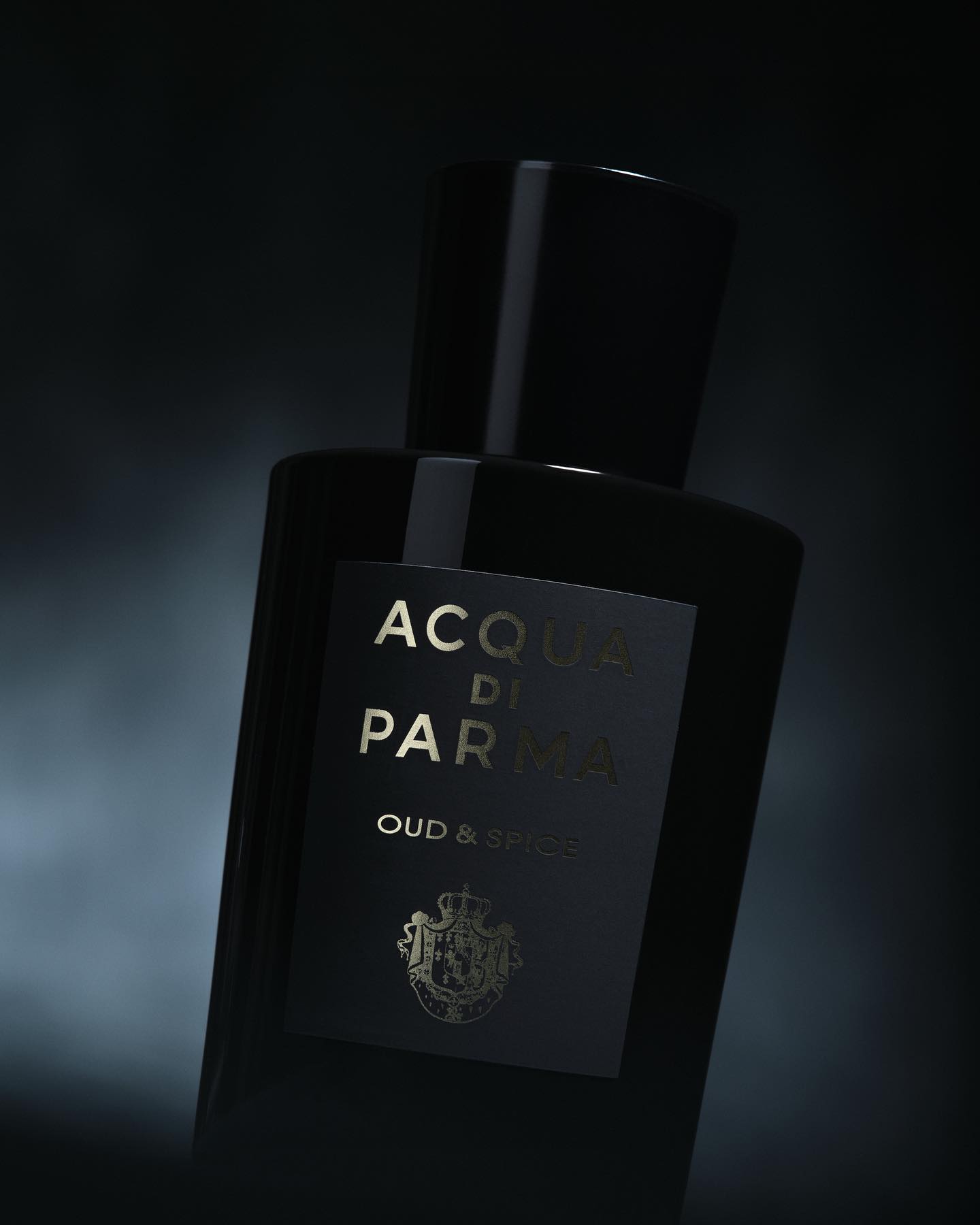 Acqua di Parma perfume bottle against a dark smoky background by Caroline Pusset