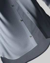 Close-up of a blue and white striped button-down shirt with light buttons against a plain background