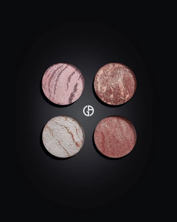 Four round Giorgio Armani beauty products in pink, bronze, and white tones displayed on a black surface, highlighting makeup textures.