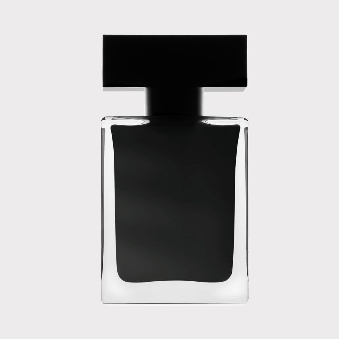 Elegant perfume bottle with a square design, featuring clear glass and a sleek black cap, against a light background.