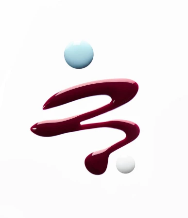 Swirls of glossy red and blue nail polish against a white background create an abstract beauty aesthetic with a modern, minimalist feel.