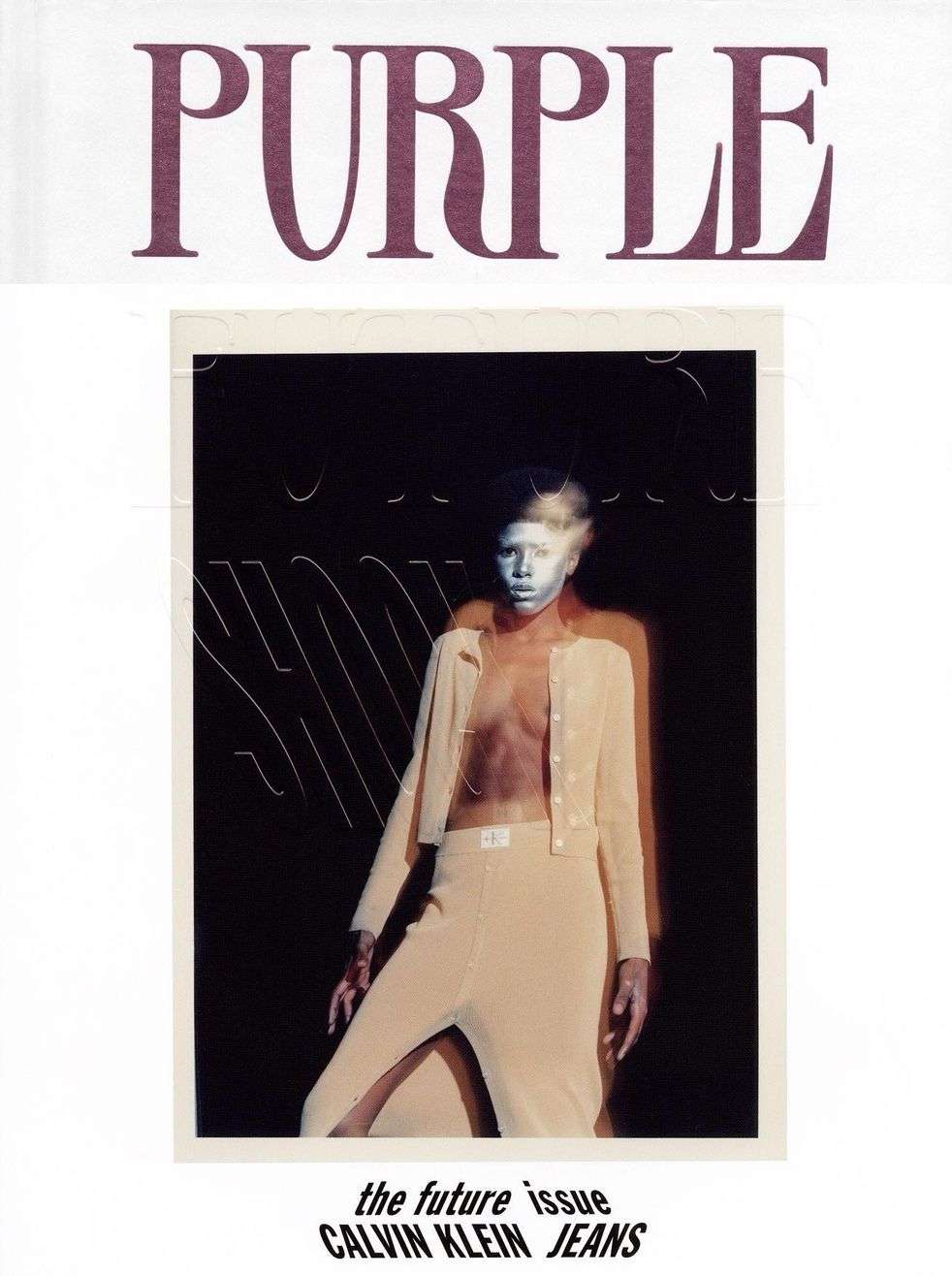 An editorial fashion magazine cover featuring a stylish model in beige pantsuit and the 'PURPLE' magazine logo.