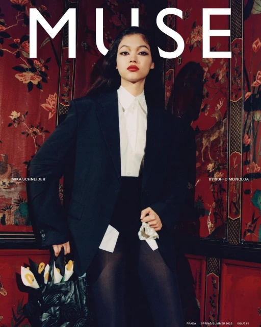 Fashion editorial cover of Muse magazine featuring a model in an oversized black blazer, white shirt, and black skirt against a floral wall.