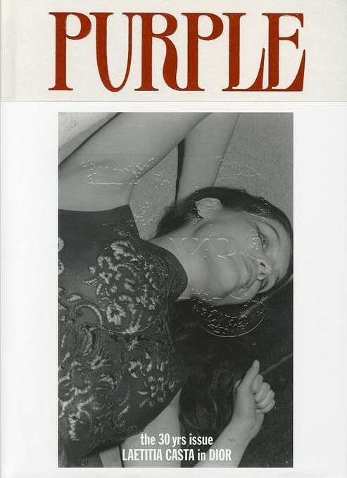 Black and white magazine cover featuring Laetitia Casta in Dior, bathed in soft light, with the masthead 'PURPLE' in red at the top.