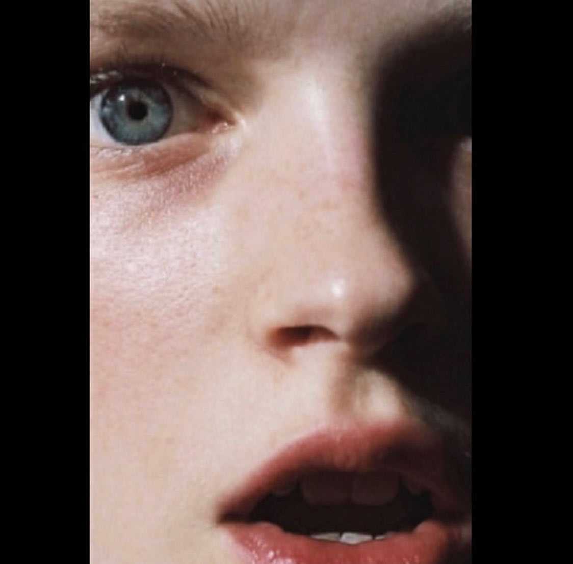 Close-up portrait of a person with blue eyes and freckles, photographed by Suffo Moncloa in New York.