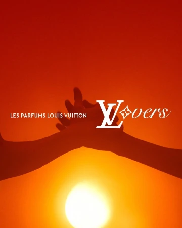 Louis Vuitton Lovers perfume advertisement featuring two hands reaching towards the sun, set against a warm orange background.
