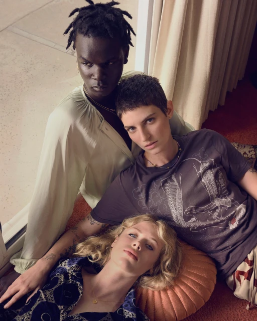 Fashion editorial featuring three models: an African American male in a light green shirt, a female with short hair, and a blonde female.