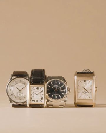 Close-up studio shot of four diverse wristwatches with leather and metal bands arranged in a row against a neutral background.