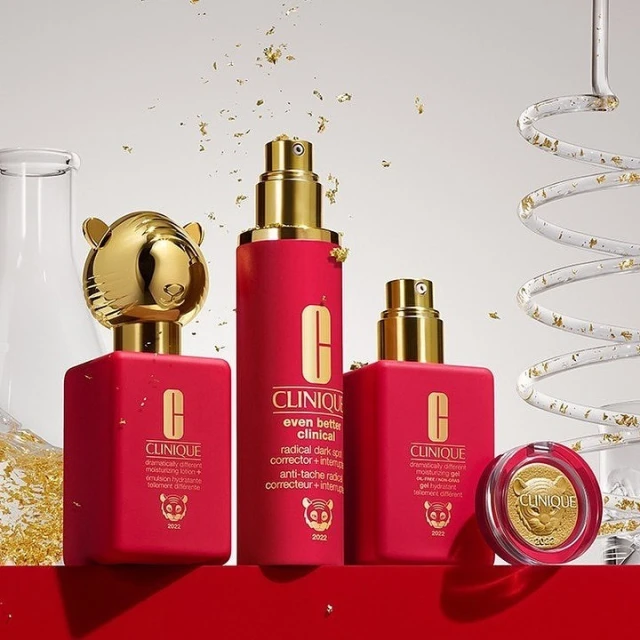 Clinique skincare set featuring a tiger motif for 2022, including lotions and creams in red packaging with gold accents.
