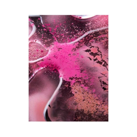 Close-up of pink and brown powder pigments on a glossy surface, creating an abstract and textured cosmetic product shot.