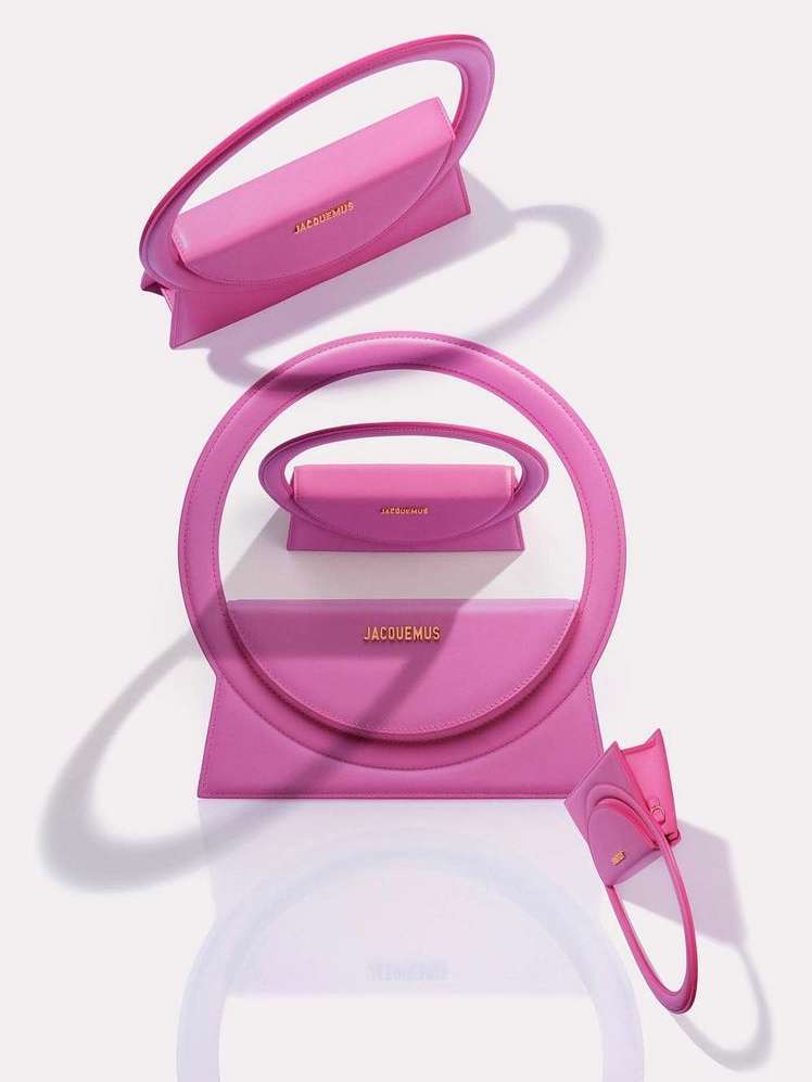 Pink Jacquemus handbag arrangement in a visually striking composition. Fashion product shot on white backdrop, highlighting the handbag's design.