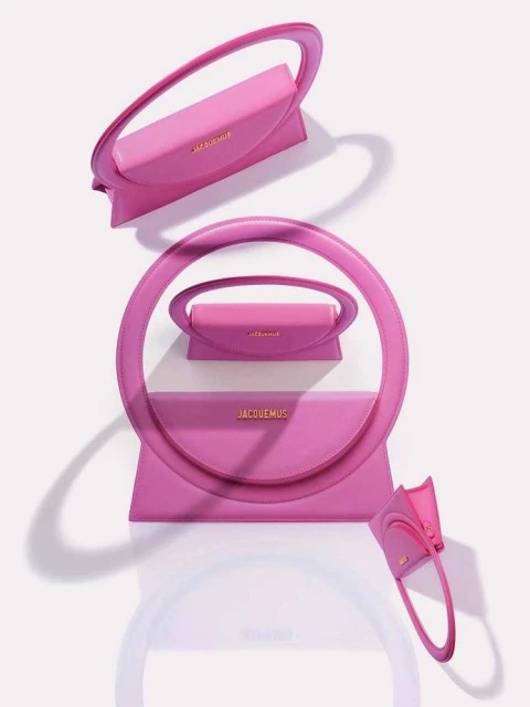 Pink Jacquemus handbag arrangement in a visually striking composition. Fashion product shot on white backdrop, highlighting the handbag's design.