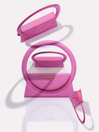 Pink Jacquemus handbag arrangement in a visually striking composition. Fashion product shot on white backdrop, highlighting the handbag's design.