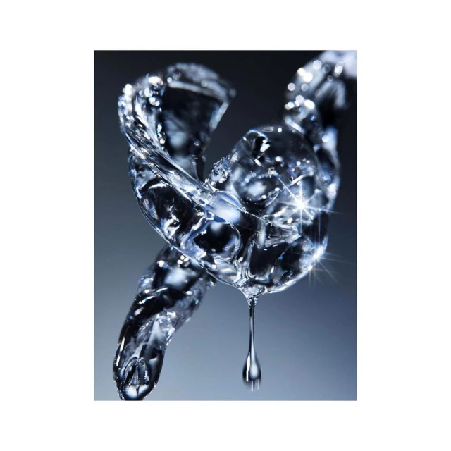 Close-up studio shot of an abstract, transparent water droplet formation with a clear liquid dripping against a grey background.