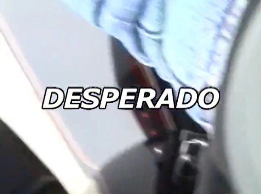 Close-up shot of car taillight with white paint and 'Desperado' text overlay, depicting automotive or entertainment content.