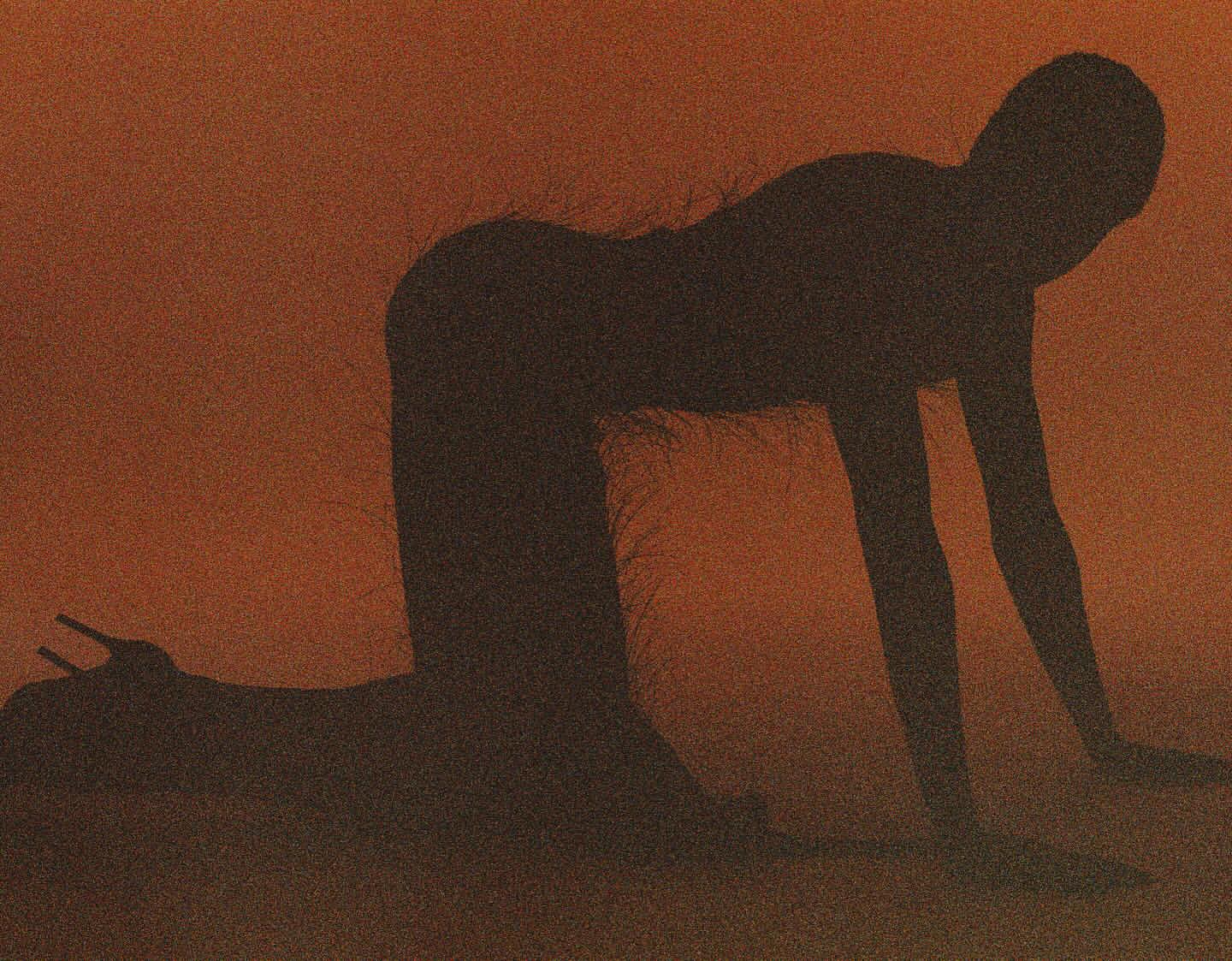Silhouette of a person in a kneeling pose with high-heeled shoes against a textured, orange background creating a dramatic, minimalist image.